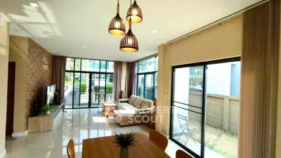 Spacious living room with modern decor and large windows for natural light.