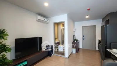 Modern apartment interior with living room and open kitchen layout, featuring sleek furniture and contemporary design.