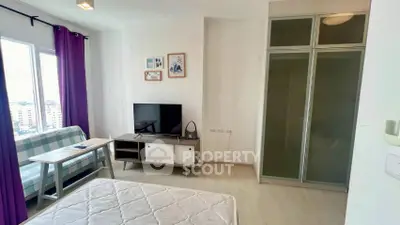 Modern studio apartment with large window and stylish decor