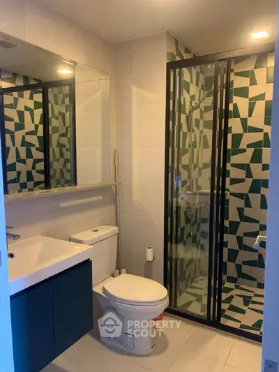 Modern bathroom with geometric tile shower and sleek vanity