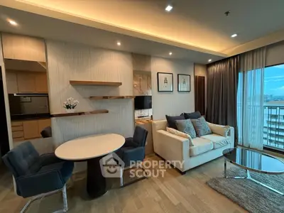Modern living room with elegant decor and city view, featuring cozy seating and stylish dining area.