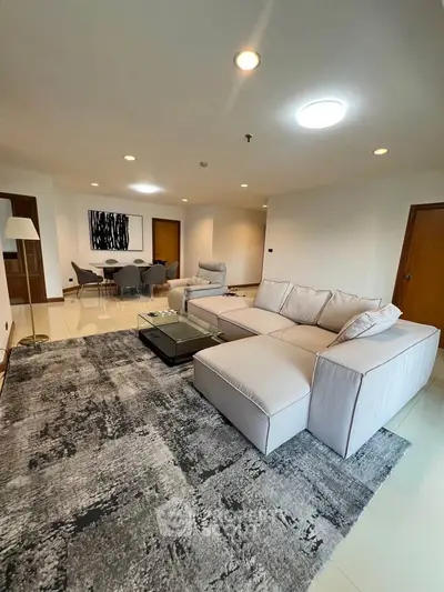 Spacious modern living room with stylish furniture and elegant decor in a contemporary apartment.