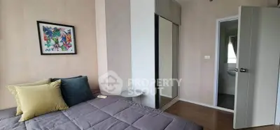 Cozy bedroom with modern decor and mirrored wardrobe in stylish apartment.