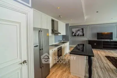 Luxurious open-layout kitchen with sleek appliances and elegant living area, perfect for modern living.