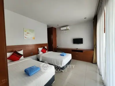Modern twin bedroom with air conditioning and natural light