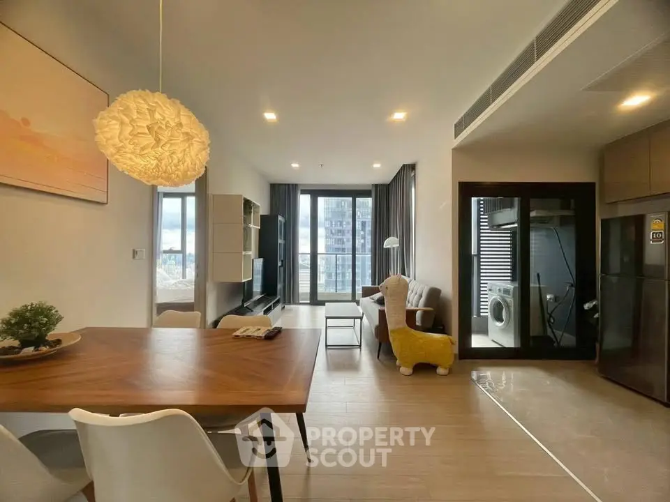 Modern living room with stylish decor and large windows offering city views