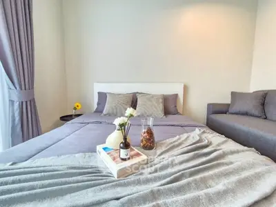 Cozy bedroom with stylish decor and comfortable bedding, perfect for relaxation.