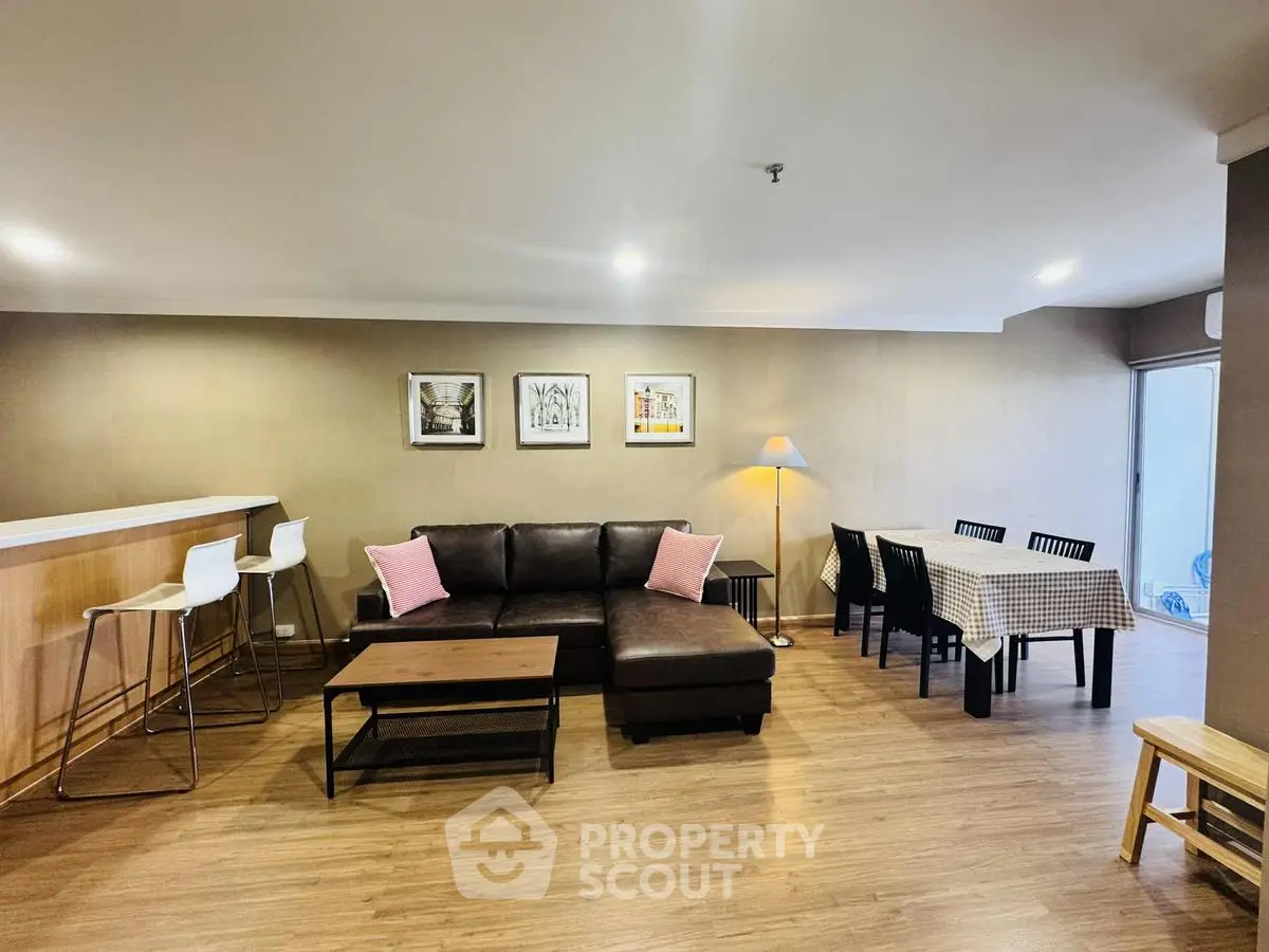 Spacious living room with modern decor, cozy seating, and dining area in open layout.