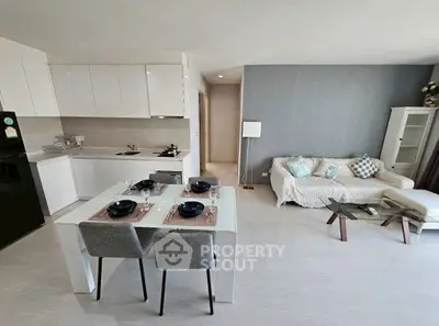 Modern open-plan kitchen and living room with stylish decor and dining area.