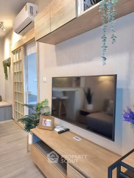 Modern living room with sleek TV setup and stylish wooden furniture