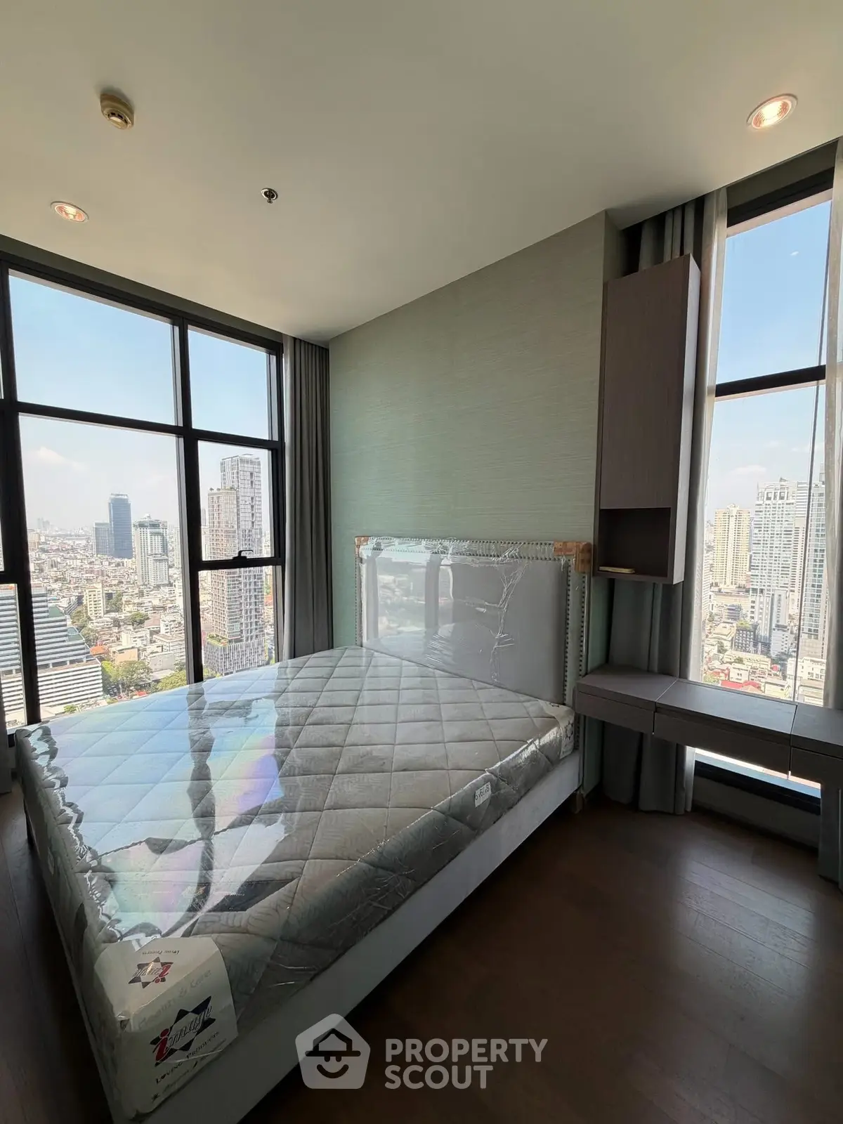 Luxurious bedroom with stunning city view in high-rise apartment