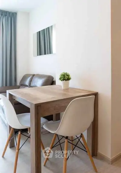 Modern living room with stylish dining table and chairs, perfect for cozy gatherings.