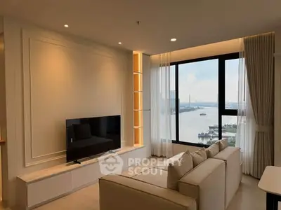Modern living room with large window offering stunning river view