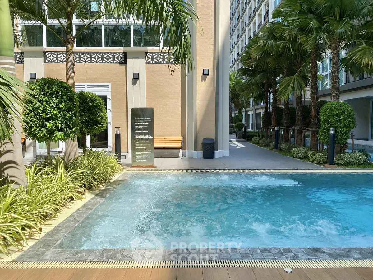 Luxurious outdoor pool area with lush greenery and modern architecture, perfect for relaxation and leisure.