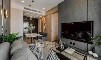 Modern living room with stylish decor, featuring a sleek TV setup and elegant dining area.