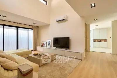 Spacious modern living room with large windows and elegant decor