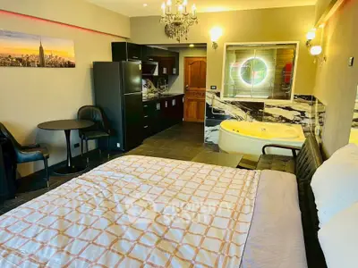 Luxurious studio apartment with modern kitchen and jacuzzi, perfect for urban living.