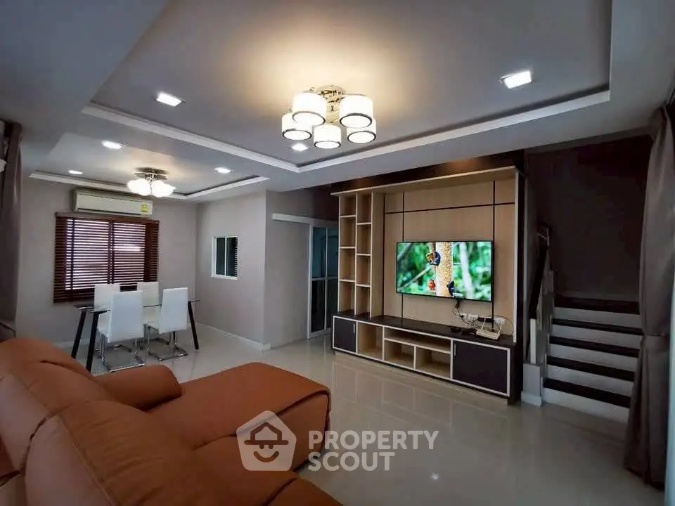 Modern living room with stylish furniture and built-in entertainment center