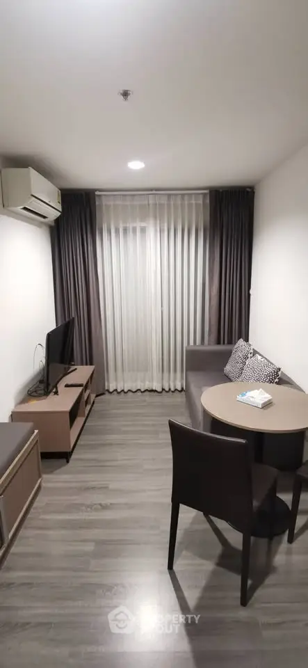 Modern living room with sleek furniture and natural light, perfect for relaxation and entertainment.
