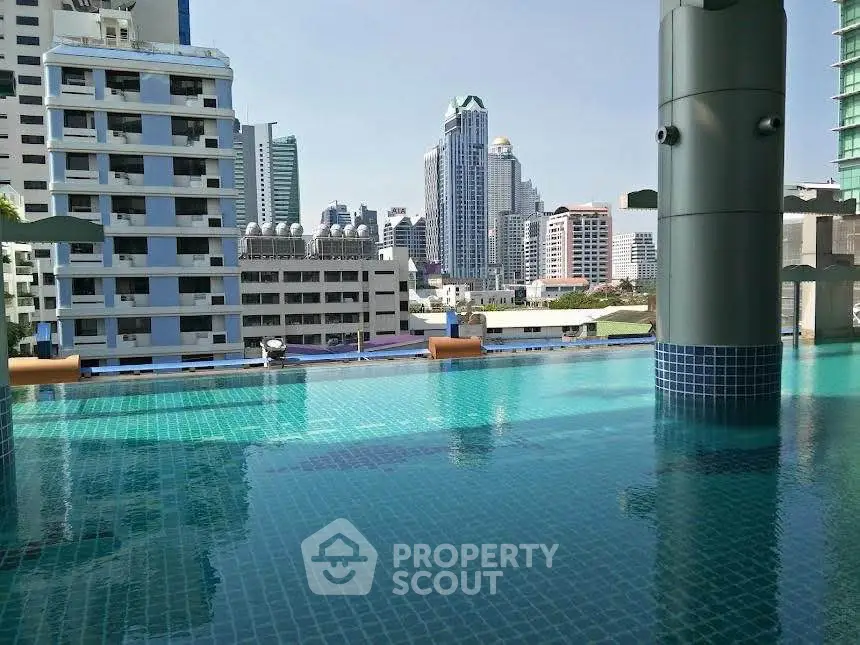 Stunning rooftop pool with city skyline view in modern urban setting.