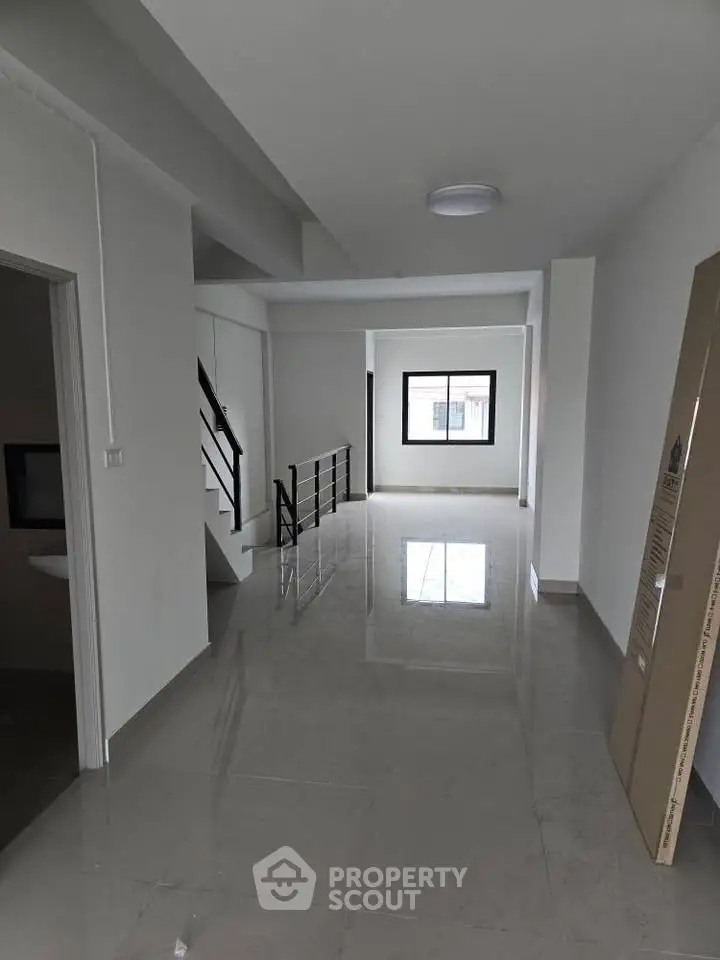 Spacious modern interior with glossy tiled floors and large windows