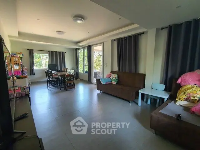 Spacious living room with modern decor and large windows for natural light