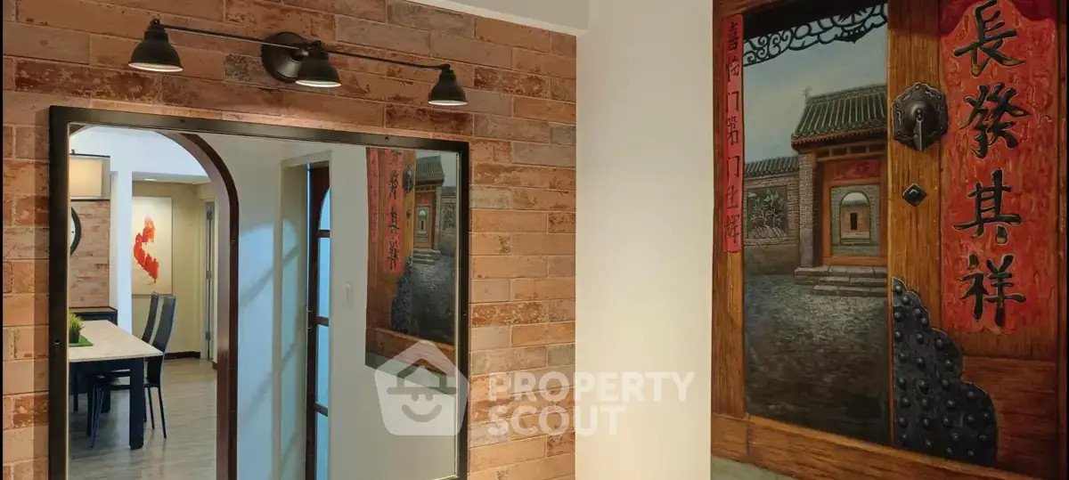 Charming interior with rustic brick wall and elegant dining area, featuring traditional Asian decor.