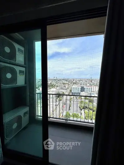 Stunning high-rise balcony view with cityscape and clear blue sky, perfect for urban living.