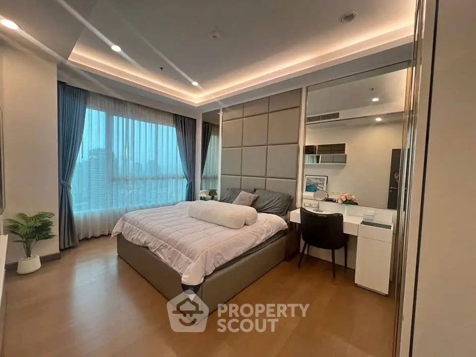 Luxurious bedroom with city view, modern decor, and cozy ambiance in high-rise apartment.