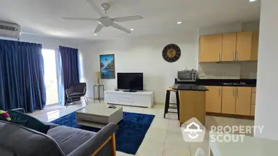 Spacious living room with modern kitchen and balcony view