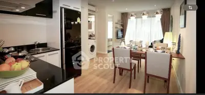 Modern open-plan kitchen and dining area with stylish decor and natural light.