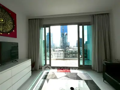 Modern living room with city view and large balcony access, featuring stylish decor and ample natural light.