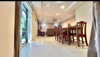 Spacious living room with elegant dining area and garden view