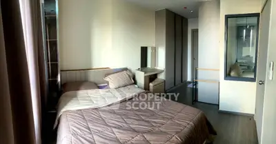 Spacious bedroom with modern decor and ample natural light