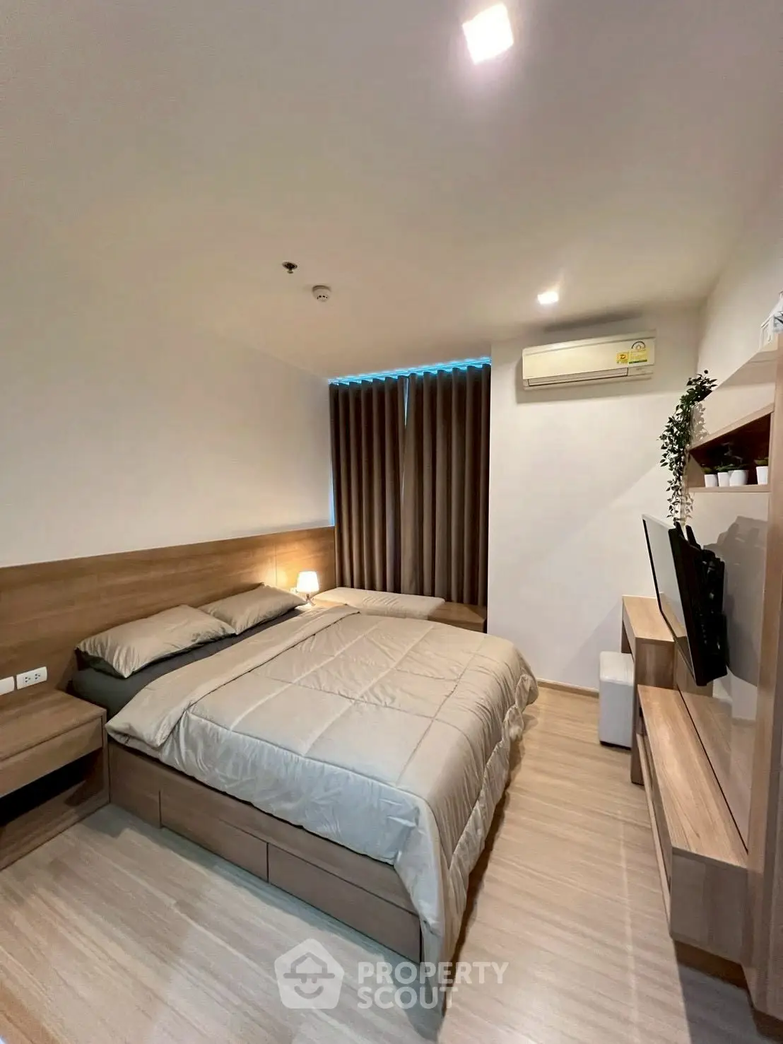 Modern bedroom with sleek wooden furniture and ambient lighting