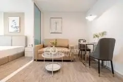 Modern studio apartment with cozy living area and stylish decor