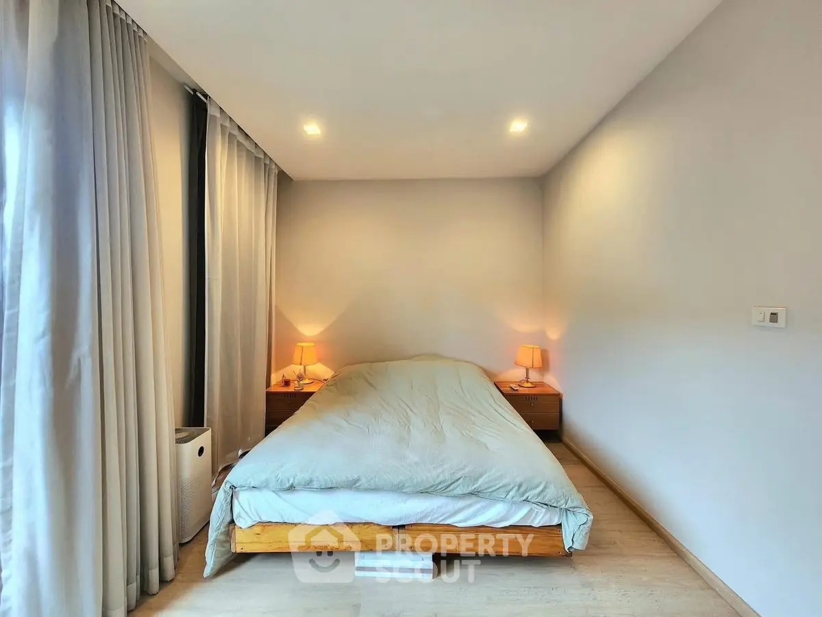 Cozy bedroom with soft lighting and modern decor, perfect for relaxation.