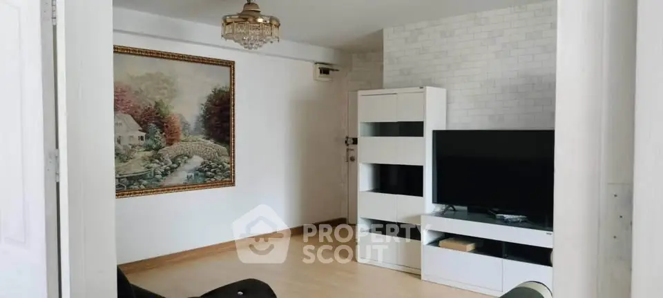 Charming living room with elegant decor and modern entertainment setup.