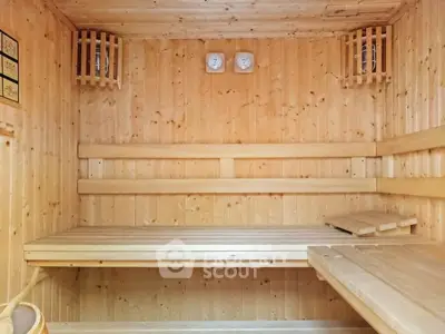 Luxurious wooden sauna room with benches and ambient lighting, perfect for relaxation and wellness.