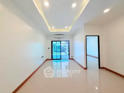 Spacious modern living room with recessed lighting and glossy tile flooring