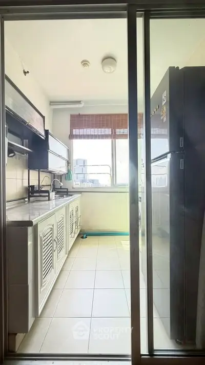 Bright kitchen with modern appliances and large window offering city views.