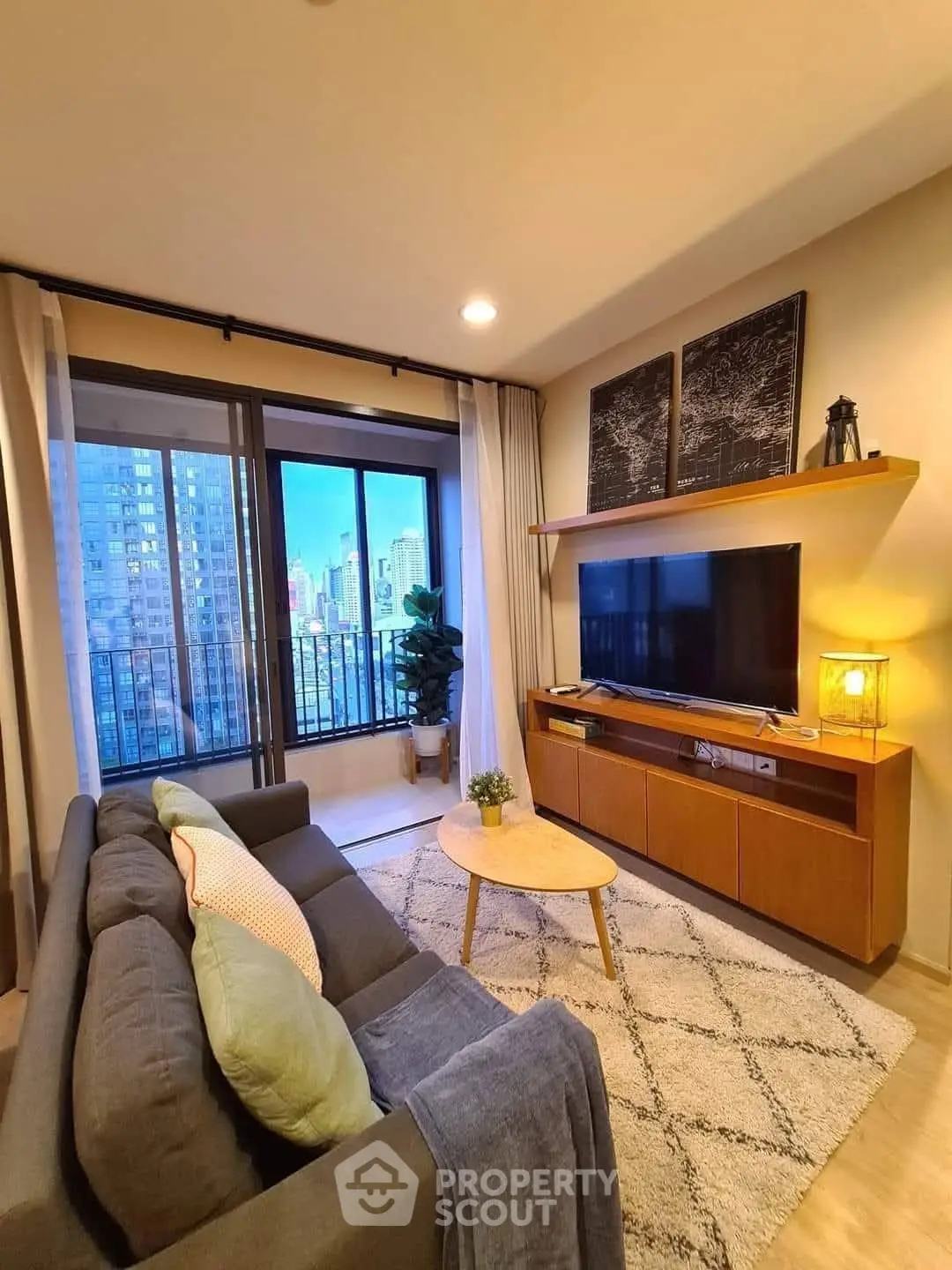 Modern living room with city view, stylish decor, and cozy seating area.