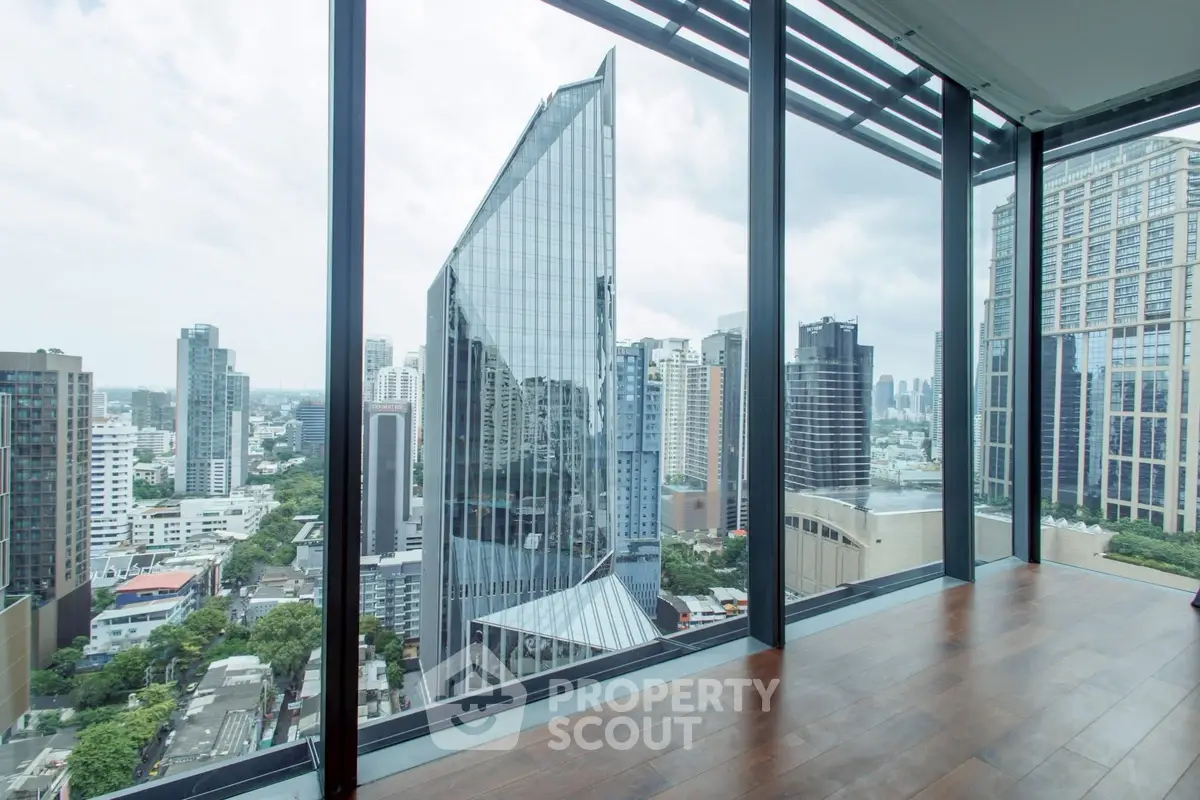 Stunning cityscape view from modern high-rise building with floor-to-ceiling windows.