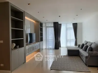 Spacious modern living room with sleek furniture and large windows for natural light.