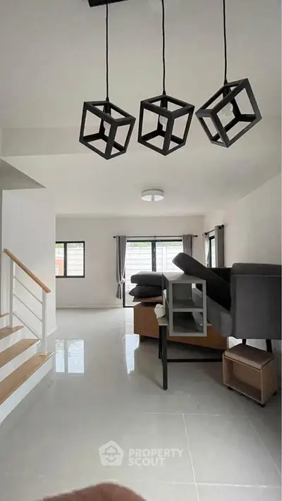 Spacious modern living room with unique cube lighting and sleek tile flooring.