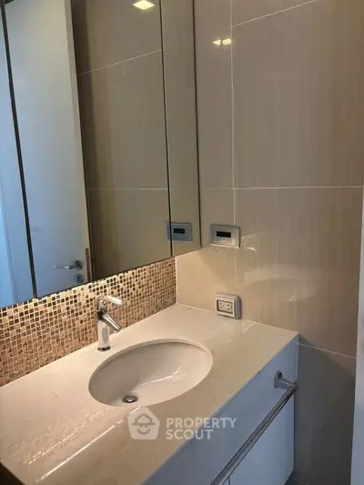 Modern bathroom with sleek vanity and stylish tile backsplash