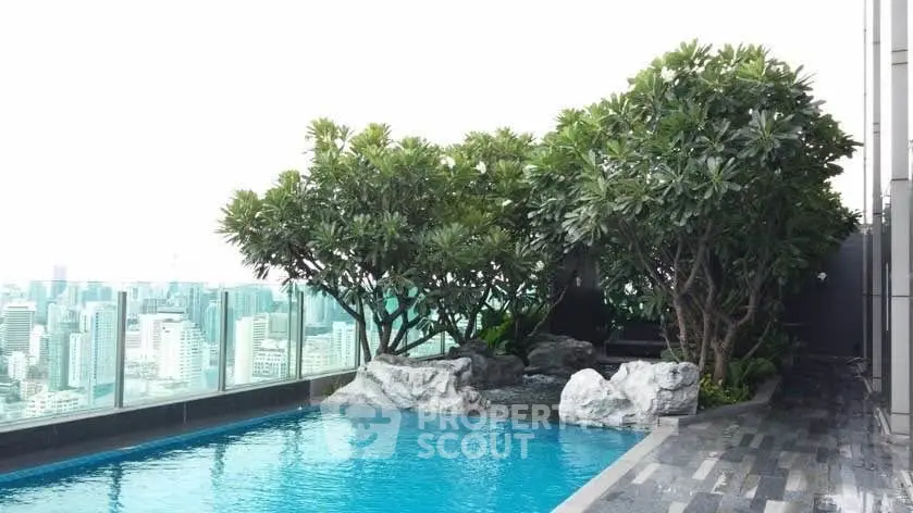 Luxurious rooftop pool with stunning city skyline view and lush greenery.