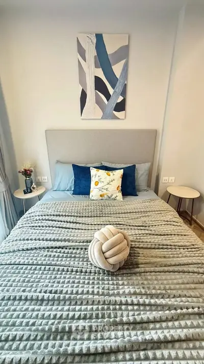 Cozy bedroom with stylish decor and plush bedding, perfect for relaxation and comfort.
