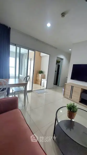 Modern living room with sleek furniture and natural light in a stylish apartment.