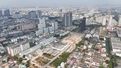 Aerial view of urban cityscape with skyscrapers and residential buildings.